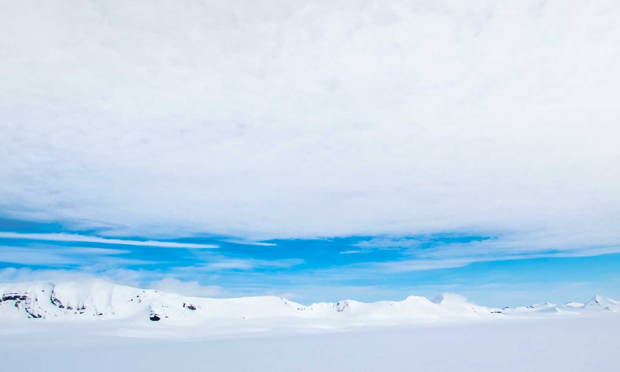 A scientist standing in an Antarctic landscape